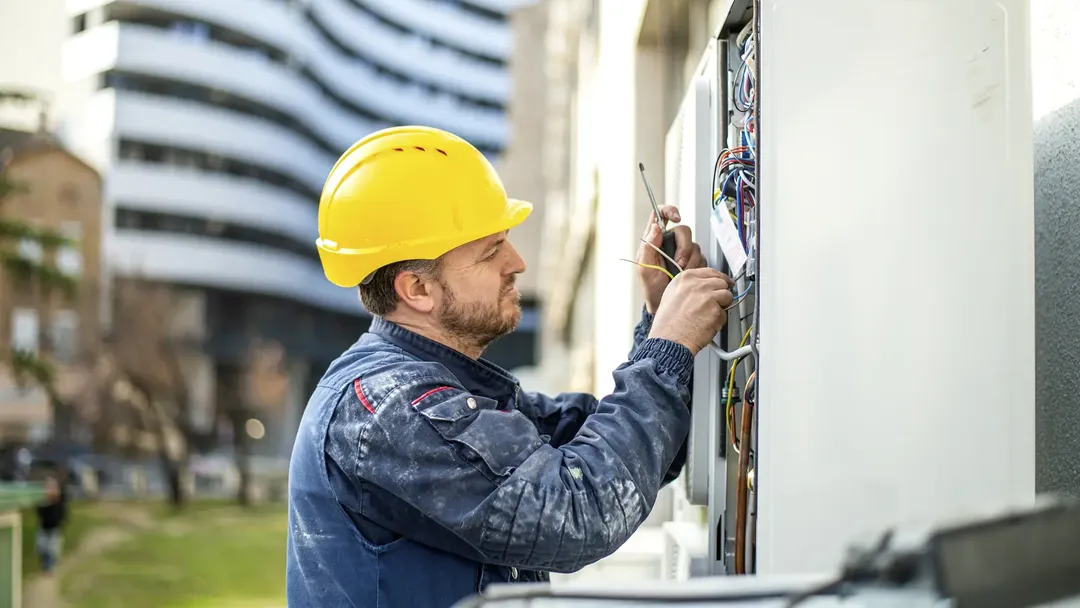 electrician-working-on-outdoor-electrical-control-panell
